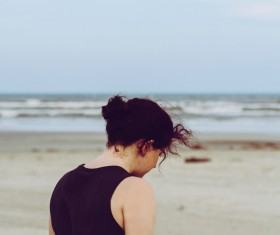 Lonely woman walking on seaside Stock Photo