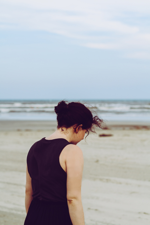 Lonely woman walking on seaside Stock Photo