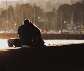 Loving couple sitting on the dock Stock Photo