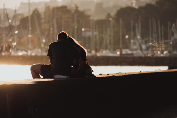 Loving couple sitting on the dock Stock Photo