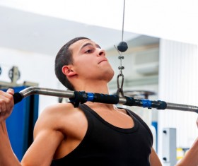 Man exercising back muscles in gym Stock Photo