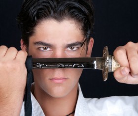 Man holding samurai sword Stock Photo