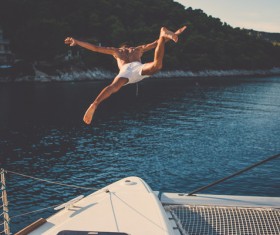 Man playing diving on the yacht Stock Photo