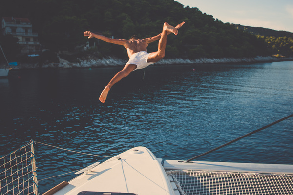 Man playing diving on the yacht Stock Photo