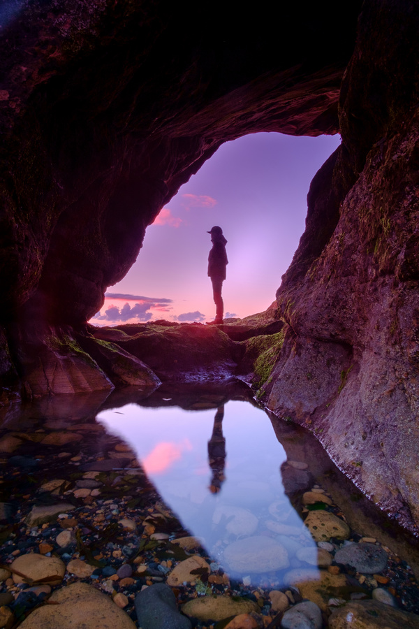 Man posing on natural rocky cave landscape Stock Photo
