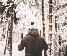 Man standing in white snowy forest Stock Photo