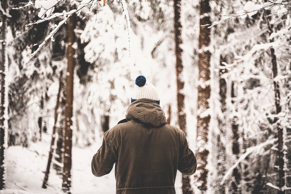 Man standing in white snowy forest Stock Photo