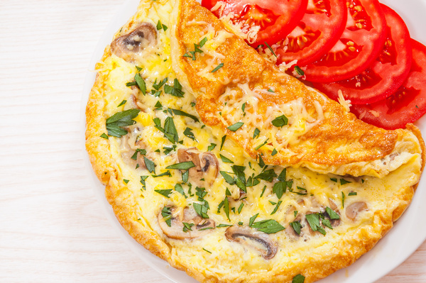 Mushroom omelet and tomato slices Stock Photo