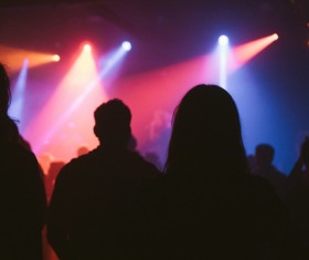 People excited in colorful lights music party Stock Photo