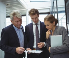 People viewing business reports together Stock Photo