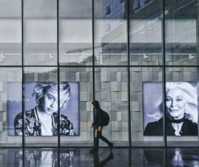 Person walking in portrait paintings gallery Stock Photo