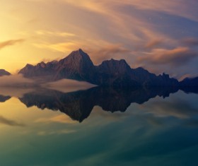 Reflection of rocky mountain on calm lake Stock Photo