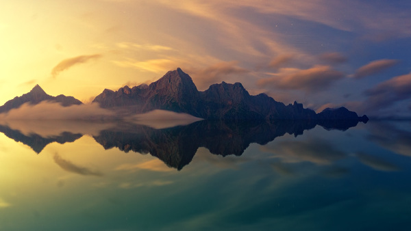 Reflection of rocky mountain on calm lake Stock Photo