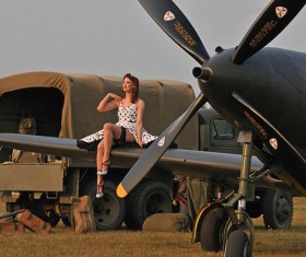 Retro woman sitting on vintage plane Stock Photo