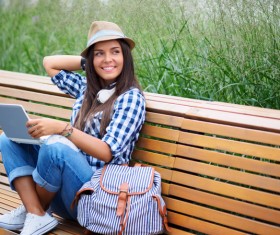 Sitting bench girl using laptop Stock Photo