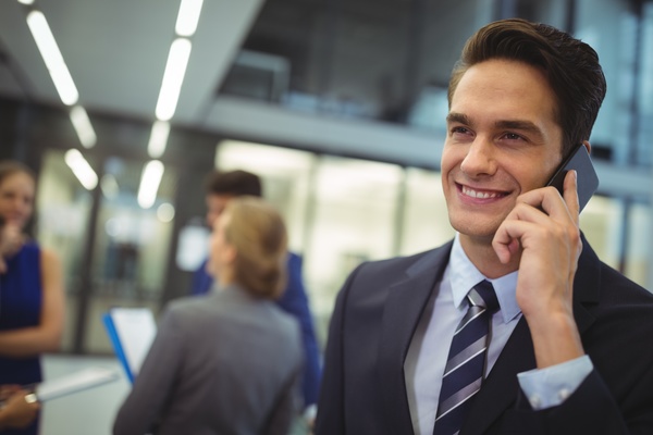 Smiling man is calling girlfriend Stock Photo