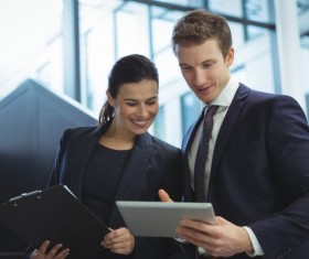 Smiling men and women looking at Tablet PC Stock Photo