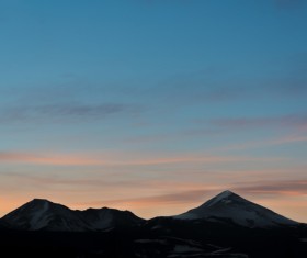 Snowy mountain range at sunset Stock Photo