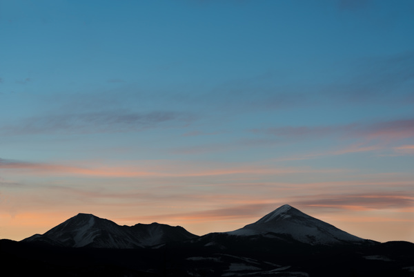 Snowy mountain range at sunset Stock Photo