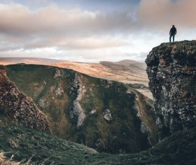 Standing in the mountains looking distant scenery man Stock Photo