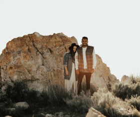 Standing near the big rock take pictures couple Stock Photo