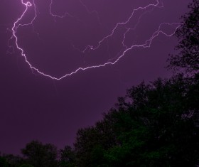 Thunderbolts on violet dark sky Stock Photo