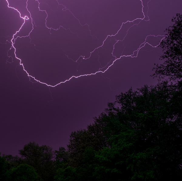 Thunderbolts on violet dark sky Stock Photo
