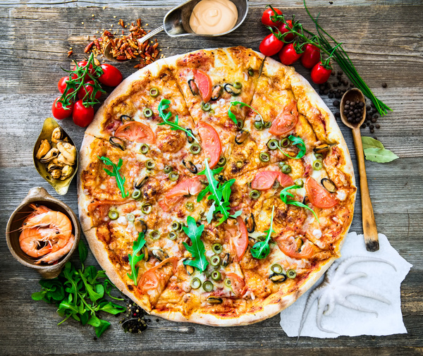Vegetables pizza and seafood on the desktop Stock Photo