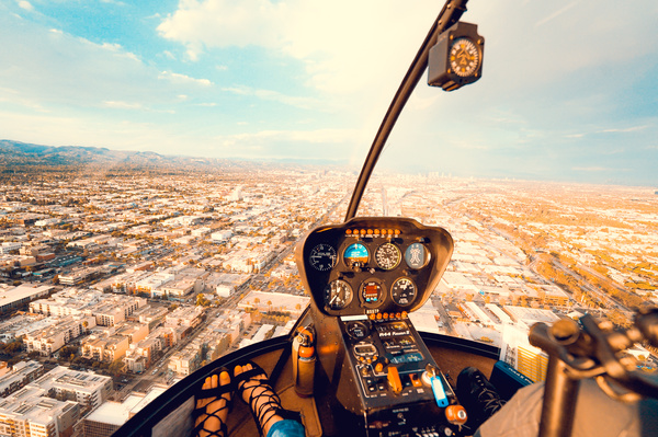 Watching cityscape on helicopter cabin Stock Photo
