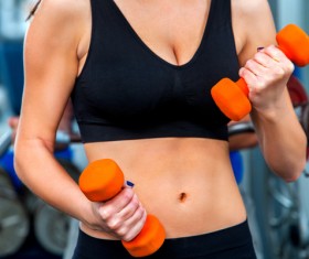 Woman doing arm exercise in gym Stock Photo 01