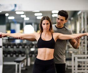 Woman doing arm exercise in gym Stock Photo 02