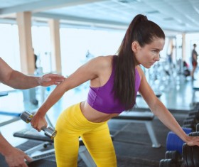 Woman doing arm exercise in the gym Stock Photo 01