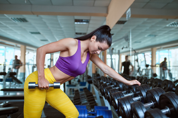 Woman doing arm exercise in the gym Stock Photo 02