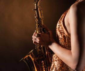 Woman holding blowing saxophone Stock Photo