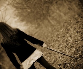 Woman holding katana back shadow Stock Photo