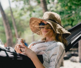Woman relaxing in hammock Stock Photo