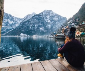 Woman sitting by the lake lonely back shadow Stock Photo