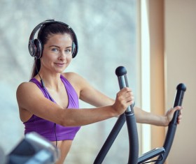 Woman with headphones doing fitness Stock Photo 02
