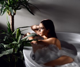 Young beautiful woman lying in bathtub Stock Photo 03