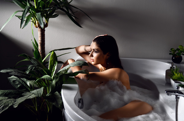Young beautiful woman lying in bathtub Stock Photo 03