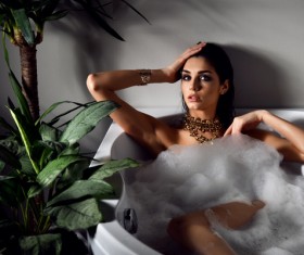 Young beautiful woman lying in bathtub Stock Photo 04