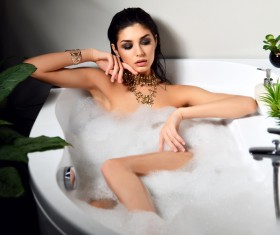 Young beautiful woman lying in bathtub Stock Photo 05
