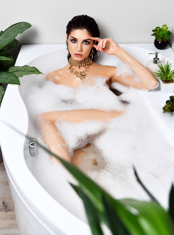 Young beautiful woman lying in bathtub Stock Photo 06