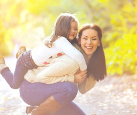 Young mother carrying daughter Stock Photo