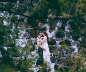 couple posing on wild stream landscape Stock Photo