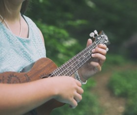girl playing guitar outdoor Stock Photo