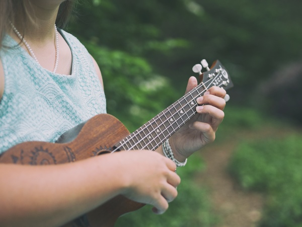 girl playing guitar outdoor Stock Photo