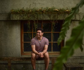 man relaxing on wooden chair Stock Photo
