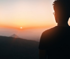 man watching mountain landscape sunset Stock Photo