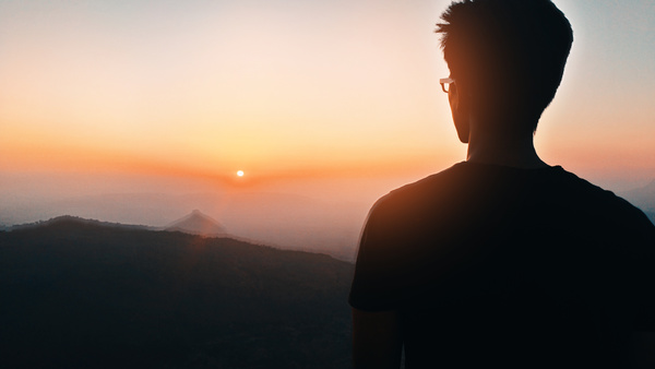 man watching mountain landscape sunset Stock Photo